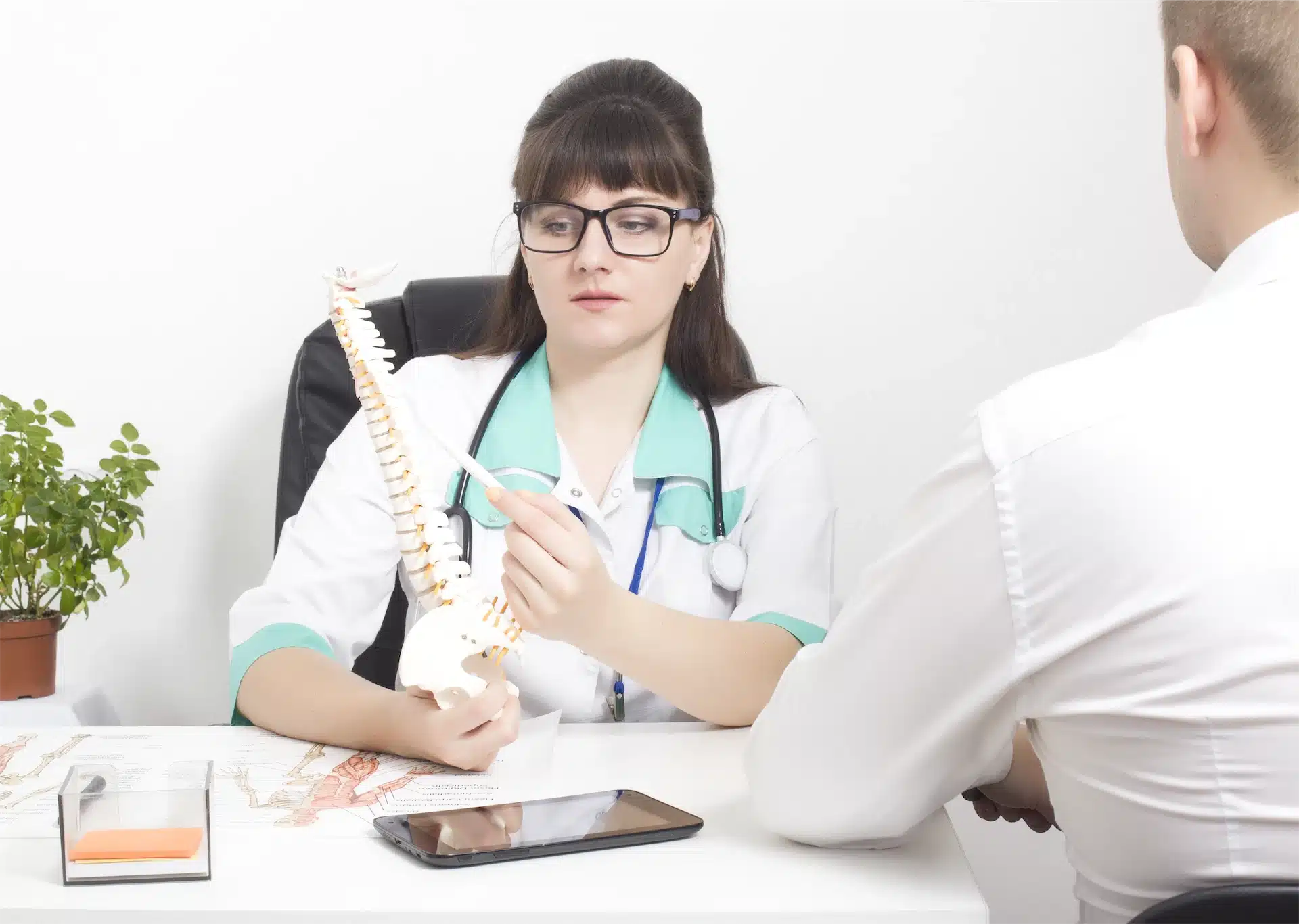 Image of Spinal Decompression Therapy for Herniated Discs explained with a spine model during a medical exam
